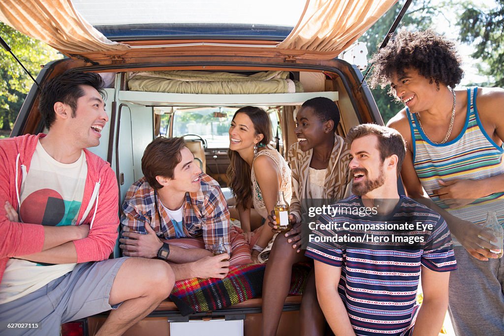 Friends relaxing in camper van