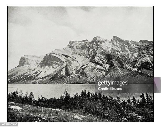 antique photograph of devil's lake or minnewauka, canadian national park - retro photograph stock illustrations