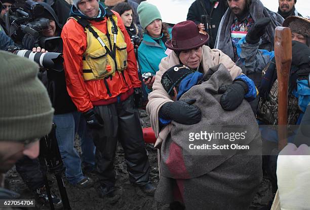 Native American activists from the Colville tribe in Washington state embrace after stepping on shore following a journey from the headwaters of the...