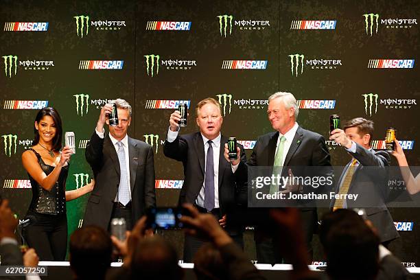 Steve Phelps, Brian France, Mark Hall and Mitch Covington toast during a press conference as NASCAR and Monster Energy announce premier series...