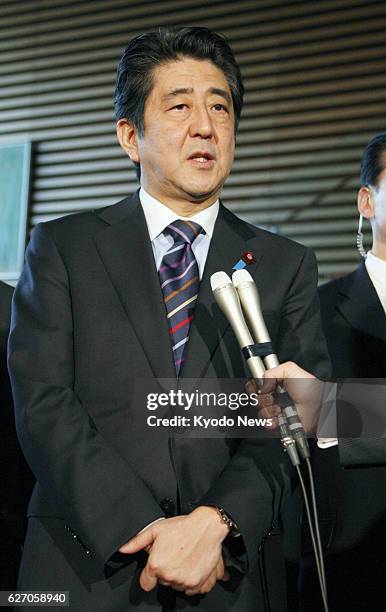 Japan - Japanese Prime Minister Shinzo Abe answers a reporter's question at his office in Tokyo on Jan. 21, 2014. Abe left for Switzerland later the...
