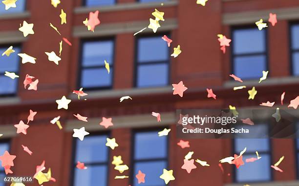 parade confetti falls from the downtown office building - thanksgiving parade stock pictures, royalty-free photos & images