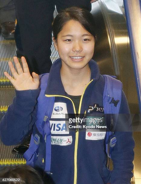 Japan - Sara Takanashi, Japan's 17-year-old gold medal hope at the Sochi Winter Olympics, waves at Narita International Airport, northeast of Tokyo,...