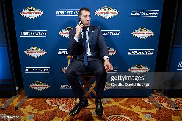 Kyle Busch talks on the phone during media availability after the NASCAR NMPA Myers Brothers Awards Luncheon at Wynn Las Vegas on December 1, 2016 in...