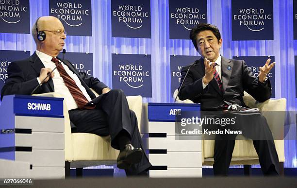 Switzerland - Japanese Prime Minister Shinzo Abe answers a question after delivering a speech at the opening session of the World Economic Forum in...