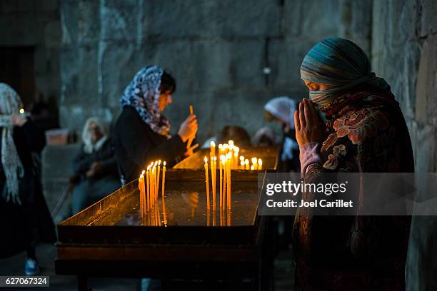 armenian woman praying at tatev monastery in armenia - armenian church stock pictures, royalty-free photos & images