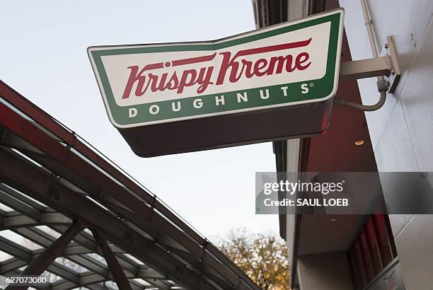 Sign for Krispy Kreme doughnuts is seen outside their store in Washington, DC, December 1, 2016. / AFP / SAUL LOEB