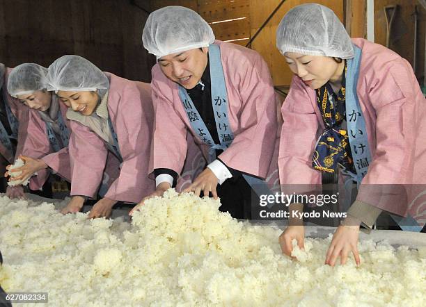 Japan - Young female managers of inns in the Kaike Onsen hot spring resort in Sakaiminato, Tottori Prefecture, spread steamed rice to make the...