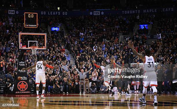 Patrick Patterson of the Toronto Raptors celebrates after sinking a buzzer beater from over half to end the 1st quarter of an NBA game against the...