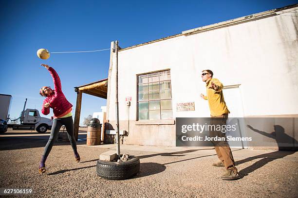 a couple playing tetherball. - tether ball stock pictures, royalty-free photos & images