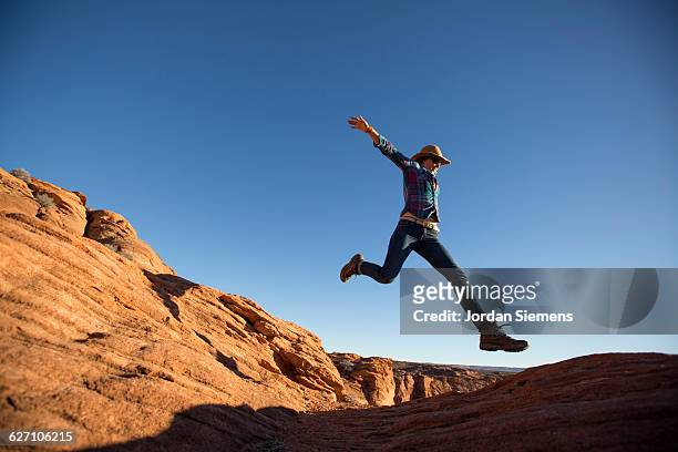 a female hiking on the edge of a senic overlook. - grand canyon stock-fotos und bilder
