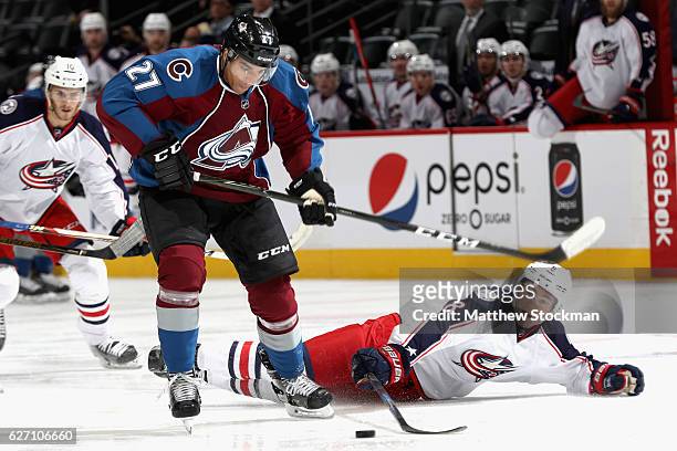 Andreas Martinsen of the Colorado Avalanche takes the puck from Zach Werenski of the Columbus Blue Jackets at the Pepsi Center on December 1, 2016 in...