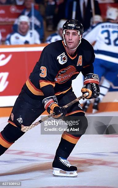 Doug Lister of the Vancouver Canucks watches the play develop against the Toronto Maple Leafs during NHL game action on December 7, 1991 at Maple...