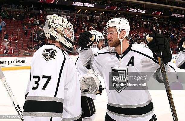Jeff Carter of the Los Angeles Kings congratulates goalie Jeff Zatkoff after a 4-3 victory against the Arizona Coyotes at Gila River Arena on...