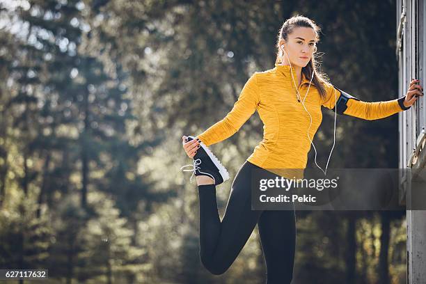 stretching before jogging - runner warming up stock pictures, royalty-free photos & images