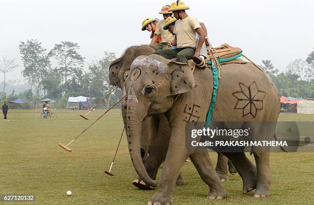 Elephant polo players from Himalyan Bank and Himalyan Tiger Foundation vie for the ball during the 35th International Elephant Polo Competition...