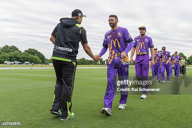 Andrew Ellis of the Kings is congratulated by Shane Watson of the Thunder following the T20 practice match between Canterbury Kings and Sydney...