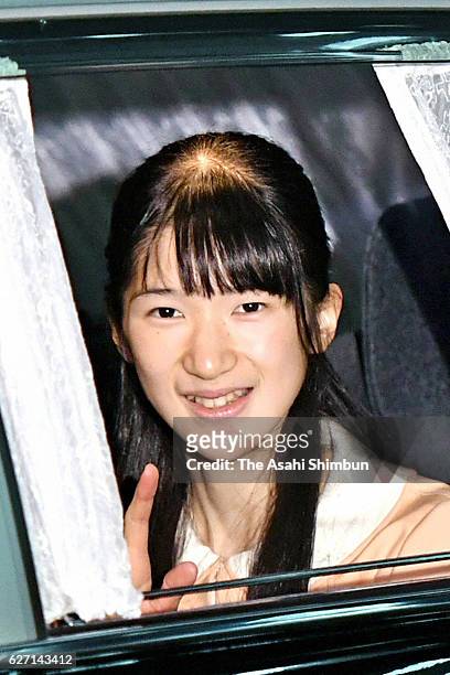 Princess Aiko waves to media reporters on arrival at the Imperial Palace to greet Emperor Akihito and Empress Michiko on her 15th birthday on...