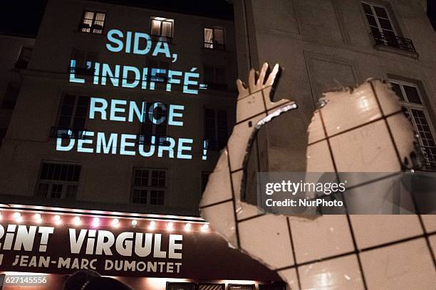 People gather for a demonstration on World AIDS Day in Paris on December 1, 2016. World AIDS Day is marked worldwide annually on December 1, to raise...