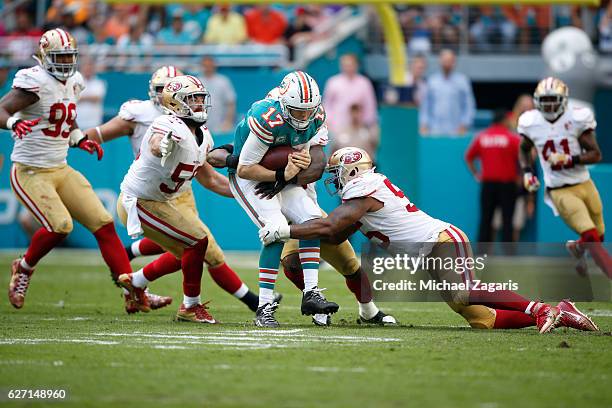 Ahmad Brooks and Gerald Hodges of the San Francisco 49ers sack Ryan Tannehill of the Miami Dolphins during the game at Hard Rock Stadium on November...