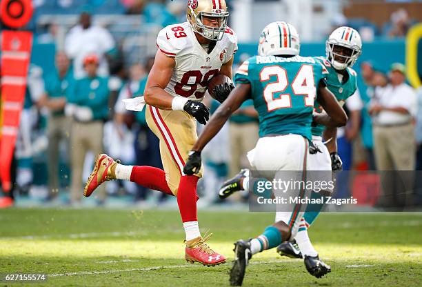 Vance McDonald of the San Francisco 49ers runs after making a reception during the game against the Miami Dolphins at Hard Rock Stadium on November...