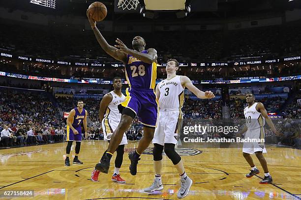 Tarik Black of the Los Angeles Lakers shoots against Omer Asik of the New Orleans Pelicans during the first half of a game at the Smoothie King...