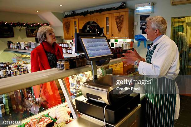 Britain's Prime Minister Theresa May speaks with Jerry Rook during a visit to a local butchers shop in her constituency of Maidenhead ahead of Small...