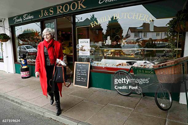 Britain's Prime Minister Theresa May leaves after visiting a local butchers shop in her constituency of Maidenhead ahead of Small Business Saturday...