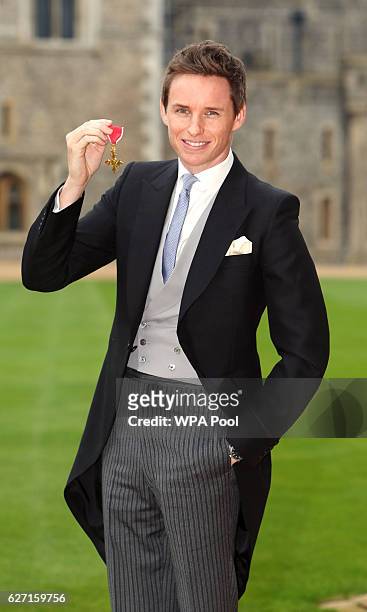 Eddie Redmayne poses after he was made an OBE by Queen Elizabeth II during an investiture ceremony at Windsor Castle on December 2, 2016 in Windsor,...