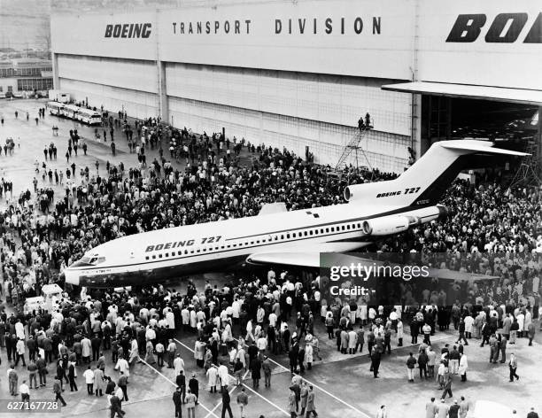 People gather for the first view of the new Boeing 727 jet airliner, developed for the short-to-medium haul market, on December 01, 1962 at Seattle,...