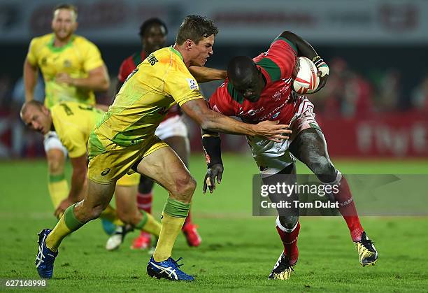 Andrew Amonde of Kenya is tackled by Ed Jenkins of Australia during day two of the Emirates Dubai Rugby Sevens - HSBC Sevens World Series match...