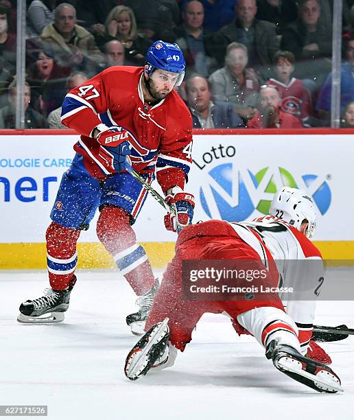 Alexander Radulov of the Montreal Canadiens passes the puck against Brett Pesce of the Carolina Hurricanes in the NHL game at the Bell Centre on...