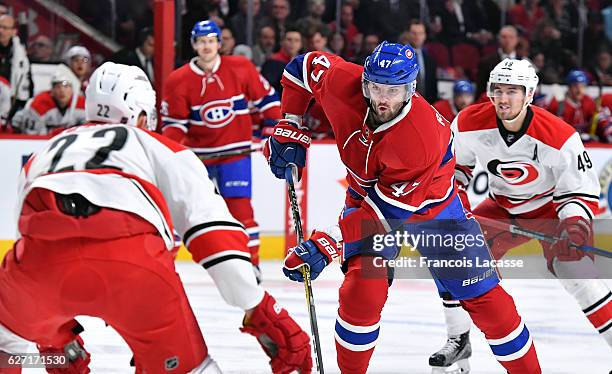 Alexander Radulov of the Montreal Canadiens passes the puck against Brett Pesce of the Carolina Hurricanes in the NHL game at the Bell Centre on...