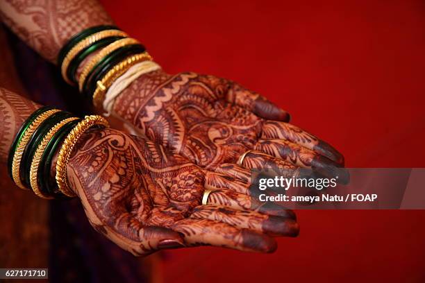 a bride showing henna decorated palms - henna hands stock-fotos und bilder