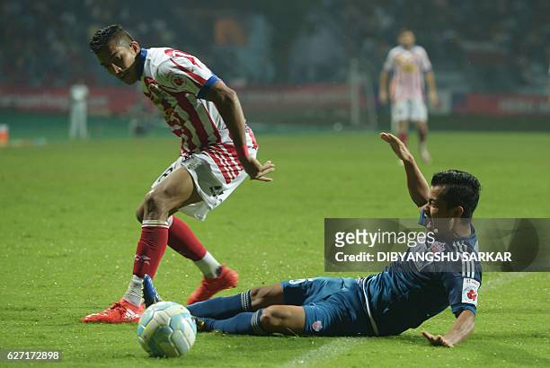 Atletico de Kolkata defender Keegan Pereira vies for the ball with FC Pune City midfielder Sanju Pradhan during the Indian Super League football...