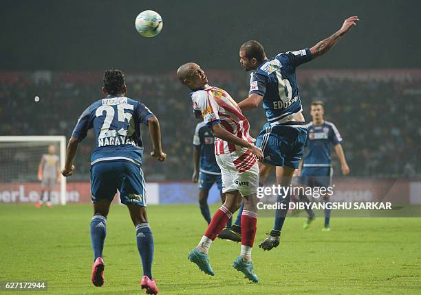 Atletico de Kolkata midfielder Ofentse Nato vies for the ball with FC Pune City defender Eduardo Ferreira during the Indian Super League football...