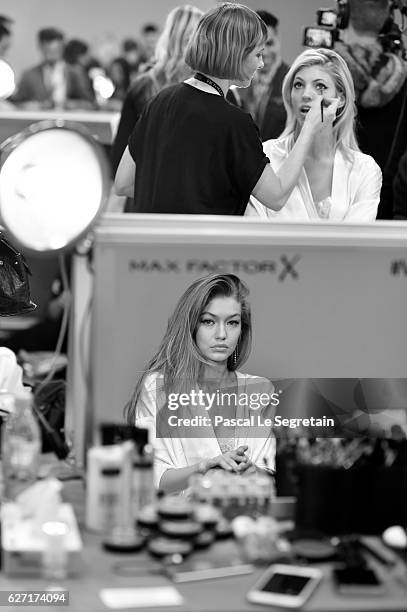 This Image has been converted to Black and White. Gigi Hadid and Devon Windsor have their Hair & Makeup done prior the 2016 Victoria's Secret Fashion...