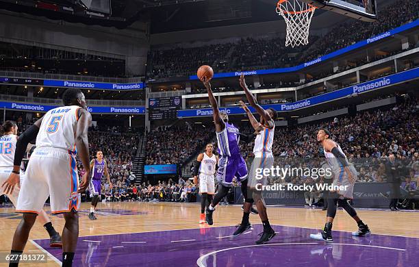 Darren Collison of the Sacramento Kings shoots a layup against Jerami Grant of the Oklahoma City Thunder on November 23, 2016 at Golden 1 Center in...