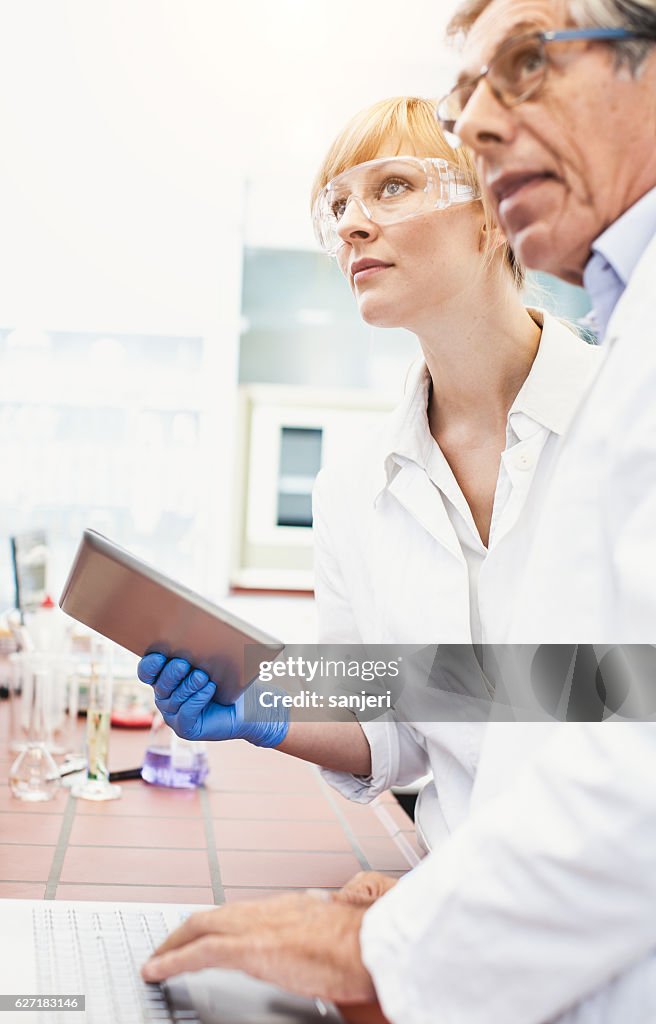 Scientists Discussing And Using Computer Software High-Res Stock Photo ...