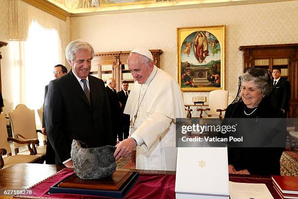 Pope Francis exchanges gifts with President of Urugay Tabare Vazquez and his wife Maria Auxiliadora Delgado during an audience at the Apostolic...