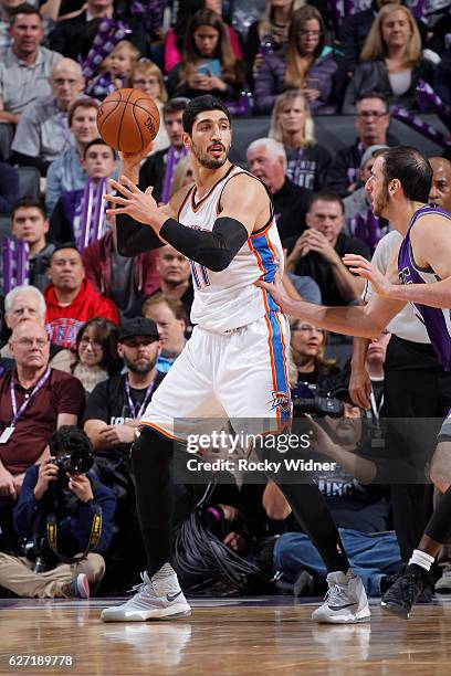 Enes Kanter of the Oklahoma City Thunder handles the ball against Kosta Koufos of the Sacramento Kings on November 23, 2016 at Golden 1 Center in...