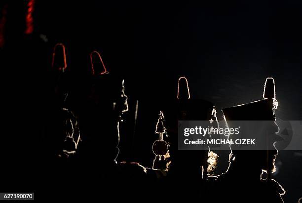 Historical re-enactment enthusiasts dressed as soldiers stand guard in front of the Peace Memorial on Prace hill on December 2, 2016 on the eve of an...