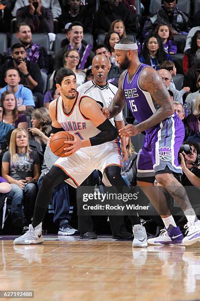 Enes Kanter of the Oklahoma City Thunder handles the ball against DeMarcus Cousins of the Sacramento Kings on November 23, 2016 at Golden 1 Center in...