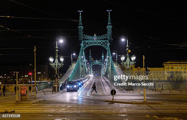 Person crosses the street in front of one of the bridges over the Danube in the City Centre on December 2, 2016 in Budapest, Hungary. The traditional...