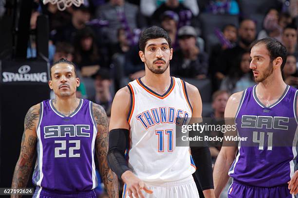 Enes Kanter of the Oklahoma City Thunder faces off against Matt Barnes and Kosta Koufos of the Sacramento Kings on November 23, 2016 at Golden 1...