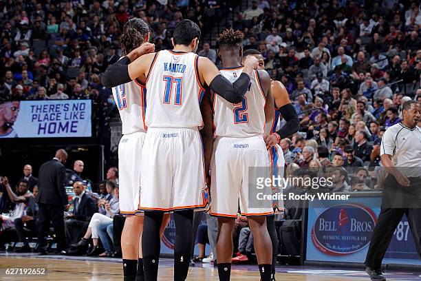 Steven Adams, Enes Kanter and Anthony Morrow of the Oklahoma City Thunder huddle up during the game against the Sacramento Kings on November 23, 2016...