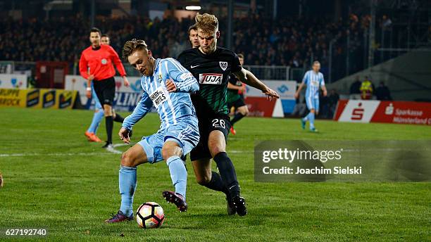 Sebastian Mai of Muenster challenges Bjoern Jopek of Chemnitz during the Third League match between Preussen Muenster and Chemnitzer FC at...