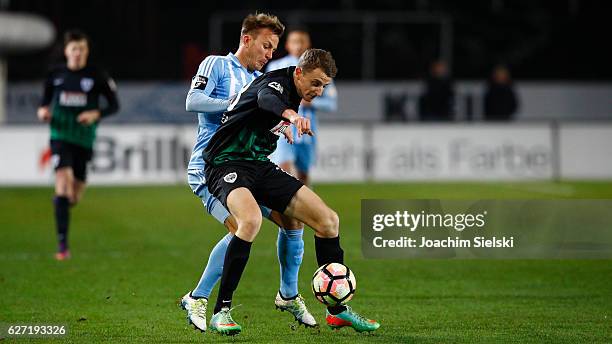 Lennart Stoll of Muenster challenges Fabian Stenzel of Chemnitz during the Third League match between Preussen Muenster and Chemnitzer FC at...