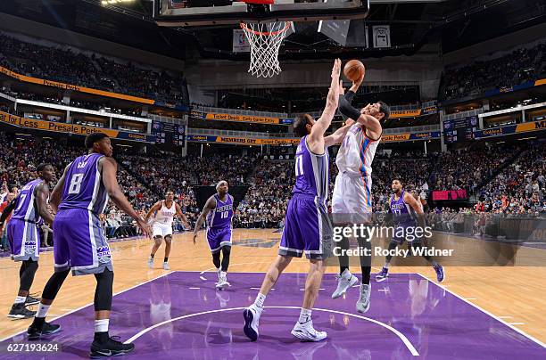 Enes Kanter of the Oklahoma City Thunder shoots against Kosta Koufos of the Sacramento Kings on November 23, 2016 at Golden 1 Center in Sacramento,...