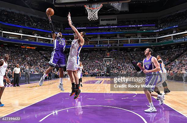 Ben McLemore of the Sacramento Kings shoots a layup against Steven Adams of the Oklahoma City Thunder on November 23, 2016 at Golden 1 Center in...